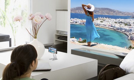 Teenage girl watching television in living room