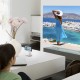 Teenage girl watching television in living room