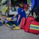 Selective focus is first aid bag. Team paramedic firs aid accident on road. Ambulance emergency service. First aid procedure.